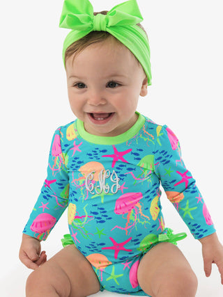 RuffleButts + RuggedButts - Baby Girls Neon Jelly Time Long Sleeve One Piece Rash Guard Swimsuit with Signature Rear Ruffles