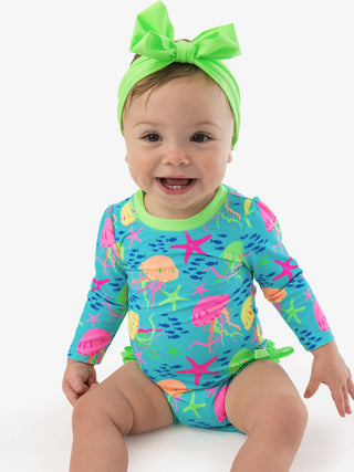 RuffleButts + RuggedButts - Baby Girls Neon Jelly Time Long Sleeve One Piece Rash Guard Swimsuit with Signature Rear Ruffles