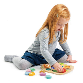 Girl Playing with Wooden Counting Acorn Toy