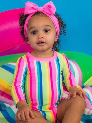 RuffleButts + RuggedButts - Baby Girls Neon Rainbow Stripe Long Sleeve One Piece Rash Guard Swimsuit with Signature Rear Ruffles