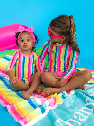 RuffleButts + RuggedButts - RuffleButts + RuggedButts - Baby Girls Neon Rainbow Stripe Long Sleeve One Piece Rash Guard Swimsuit with Signature Rear Ruffles - Classy Rascals Boutique
